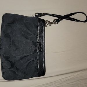Small, black Coach wristlet.